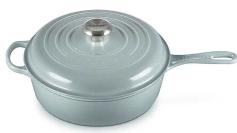 A bluish green pot with a matching handle