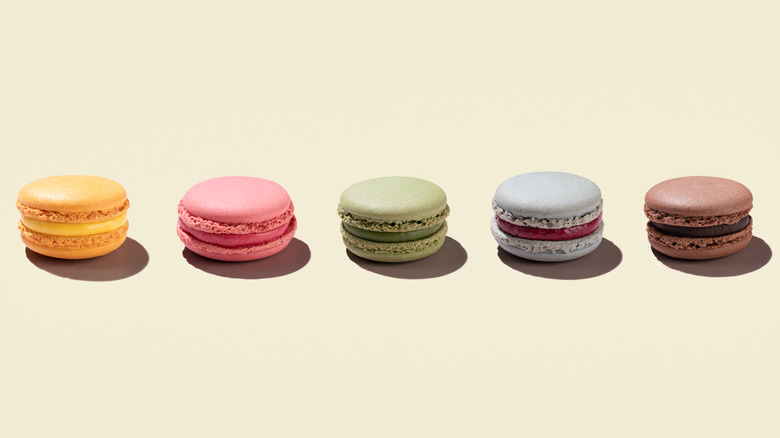 colorful macarons on light peach background