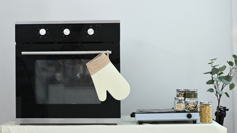 oven with oven mitt hanging from it