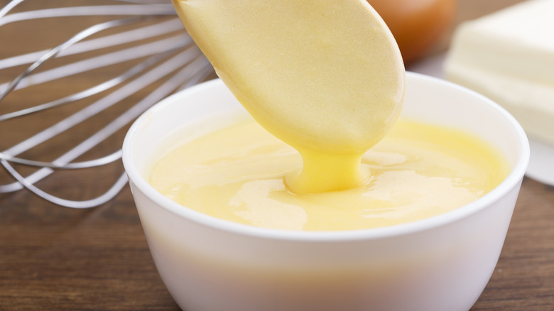 smooth hollandaise sauce on spoon