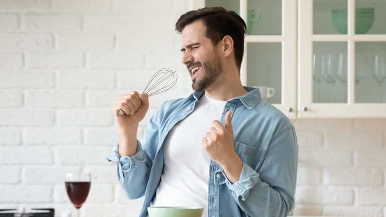 man looking happy while cooking