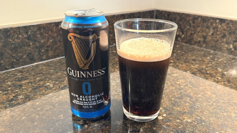 Guinness 0 beer with glass on countertop