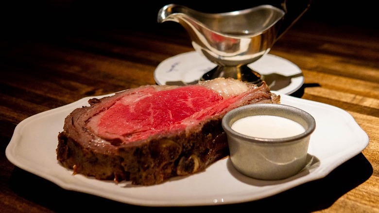A slice of prime rib with horseradish on a plate at 4 Charles Prime Rib