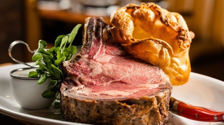 A slice of prime rib and Yorkshire pudding on a plate at Brass Ram