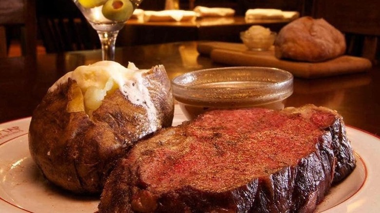A plate of prime rib and baked potato at Highland Tap