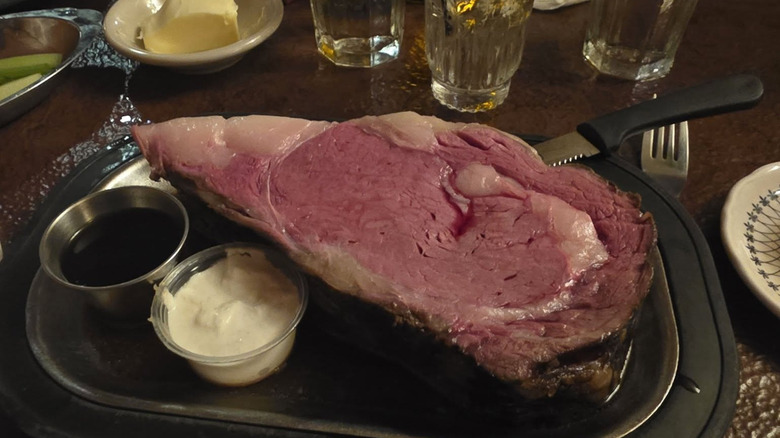 A slice of prime rib on a plate with horseradish and au jus at Wiederholt's Supper Club