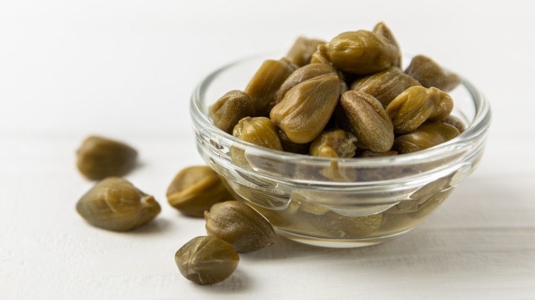 glass bowl of capers on table