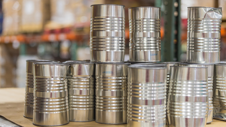 dented metal cans in a stack