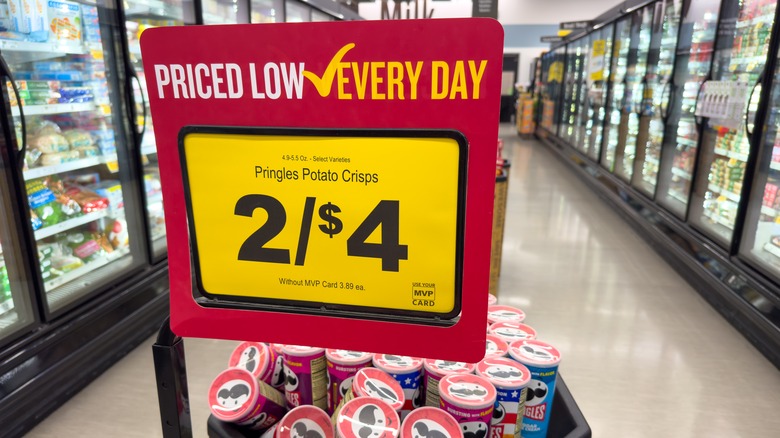 A sign advertising a two for $4 deal on pringles