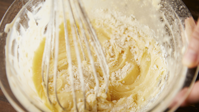 Person mixing cake batter in a bowl