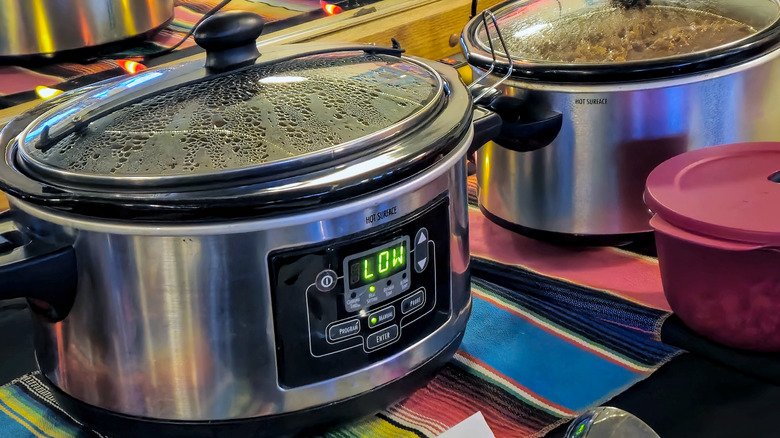 Food cooking in a slow cooker set on LOW