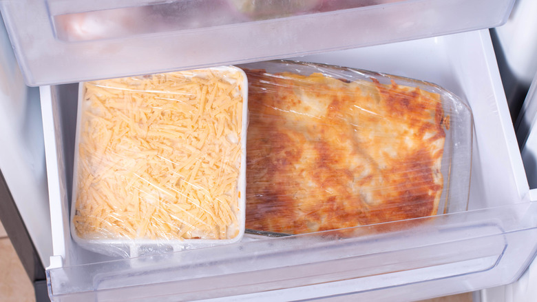 Two wrapped casserole dishes in the freezer