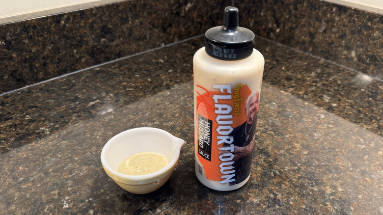 Honey mustard with ramekin on a counter