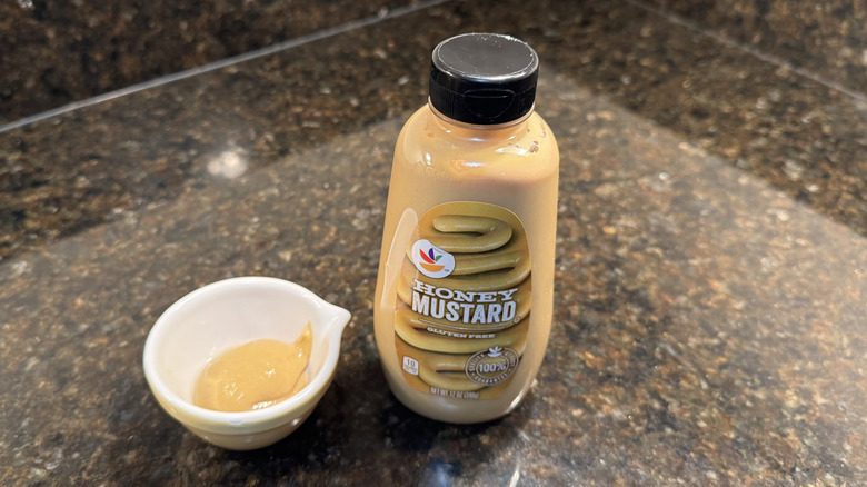 Honey mustard with ramekin on a counter