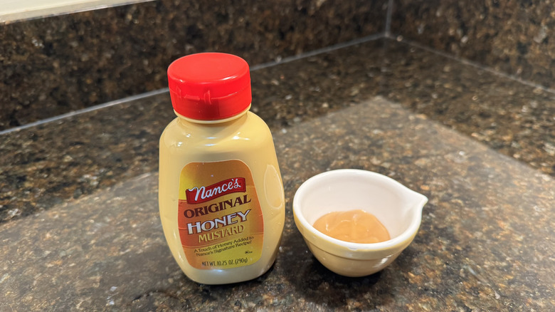 Honey mustard with ramekin on a counter
