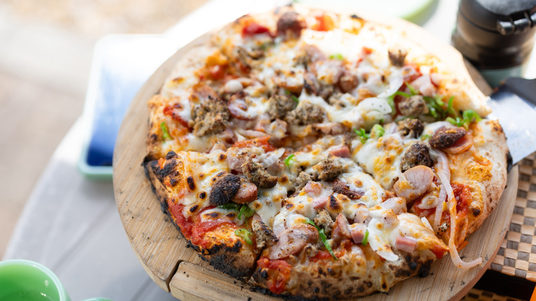 Homemade pizza with meat and veggie toppings
