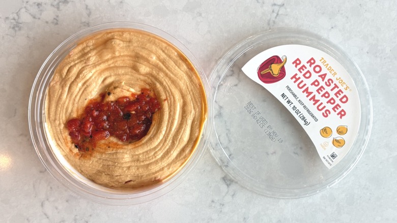 An open container of Trader Joe's Roasted Red Pepper Hummus