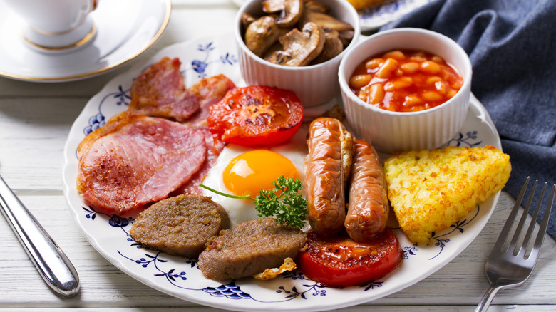 Irish bacon (rashers) on the left edge of a plateful of English breakfast