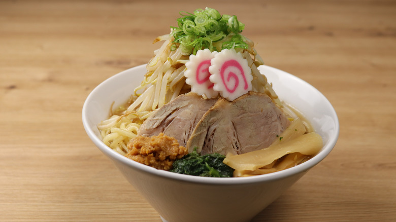 A bowl of jiro ramen is piled high with various toppings