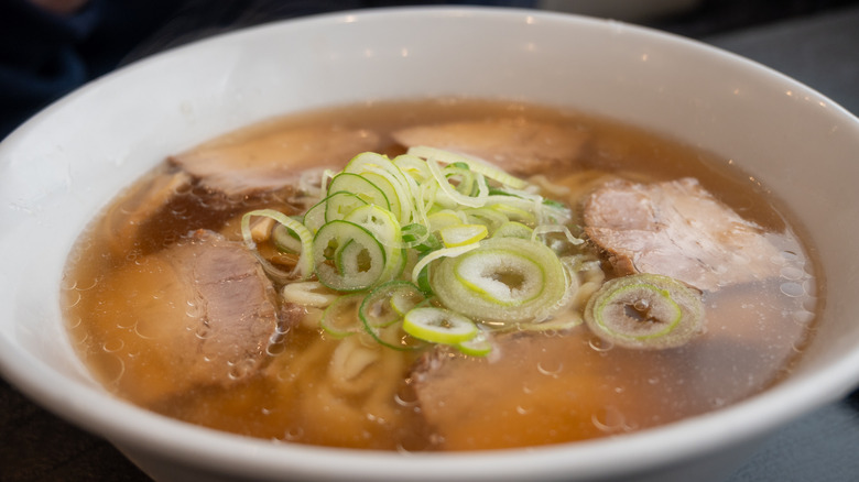 A bowl of kitakata ramen with sliced scallions