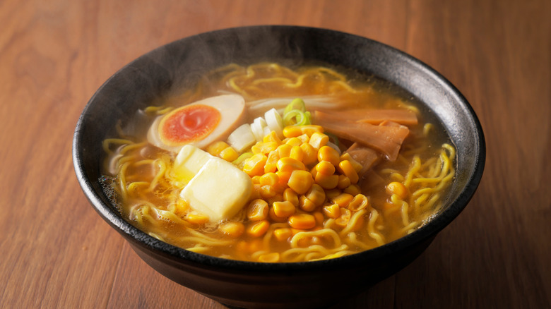 A steaming bowl of sapporo style ramen with pat of butter and other toppings