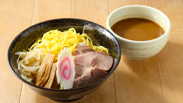 a bowl of tsukemen with its dipping sauce and toppings