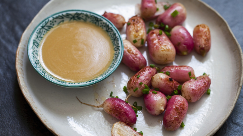 Miso dressing served on a plate with roasted radishes