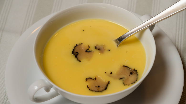 a bowl of Fonduta Valdostana topped with shaved black truffles