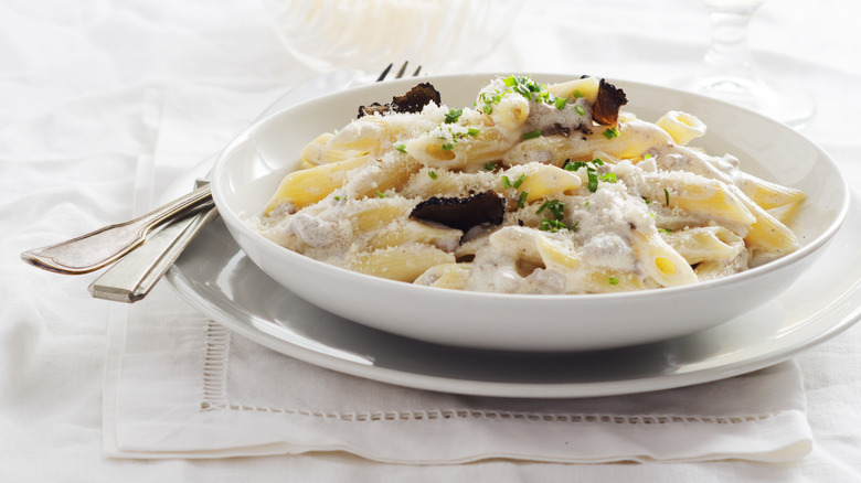 A plate of pasta alla norcina on a set table