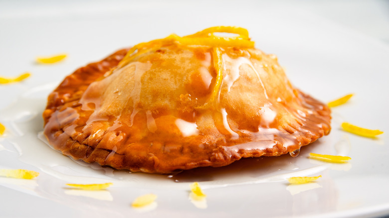 A golden brown seadas drizzled with honey and lemon zest