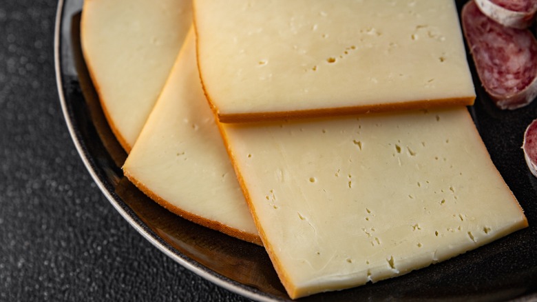 Slices of raclette cheese on a plate