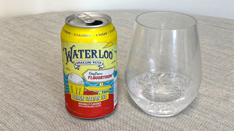 Lemon Italian Ice Waterloo can on a table beside a glass of it