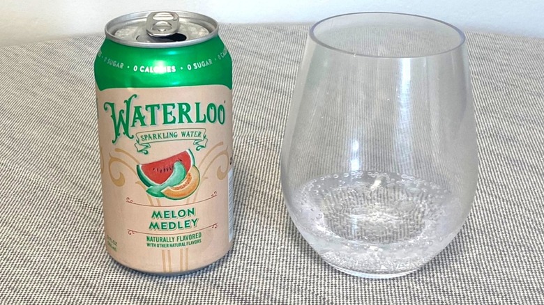 Melon Medley Waterloo in a can on a table beside a glass of it