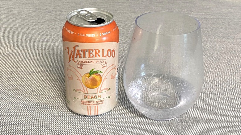 Peach Waterloo flavor in a can next to a glass