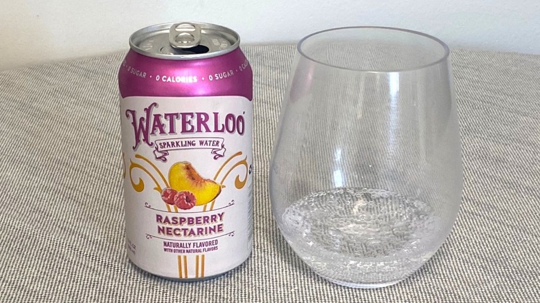 Raspberry Nectarine Waterloo in a can on a table beside a glass of it