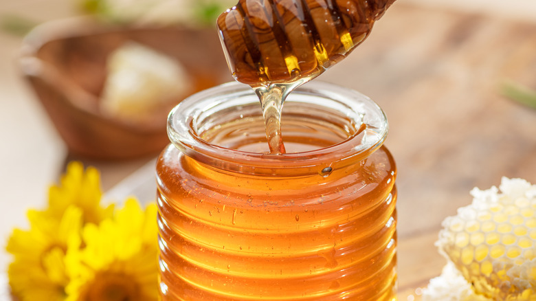 Jar of honey with scooper