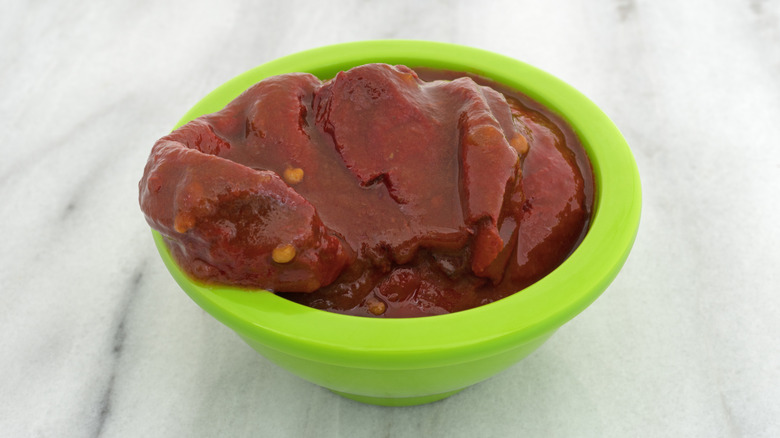 Green bowl of chiles in adobo sauce