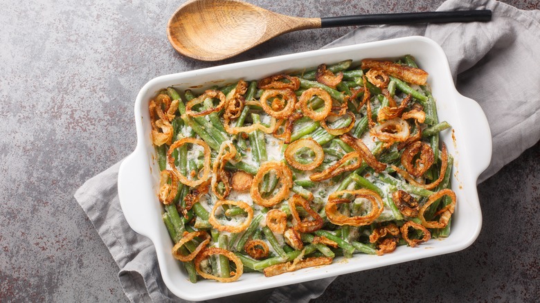 Overhead view of a baking dish filled with creamy green bean casserole