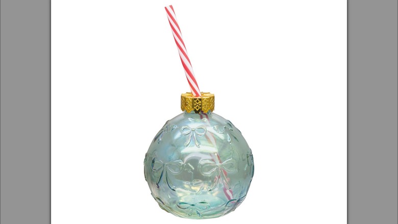 A glass Christmas ornament sipper cup with a straw