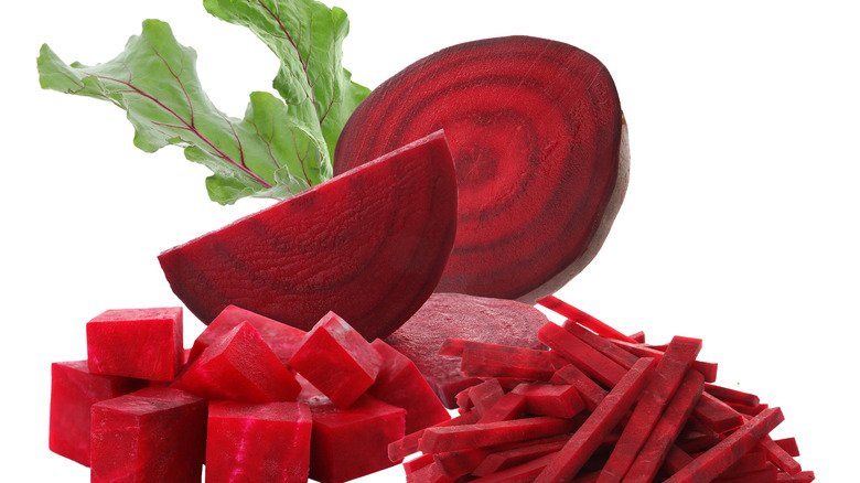 Beets whole and chopped on white background