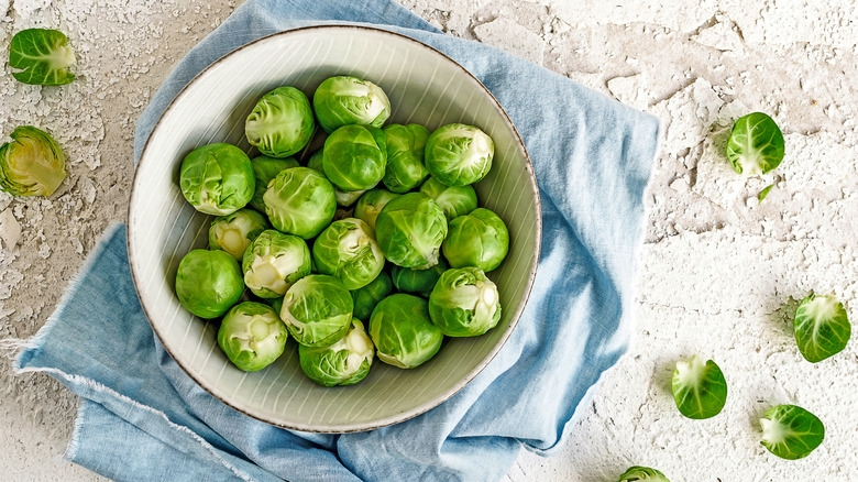 Brussels sprouts in a bowl with towel