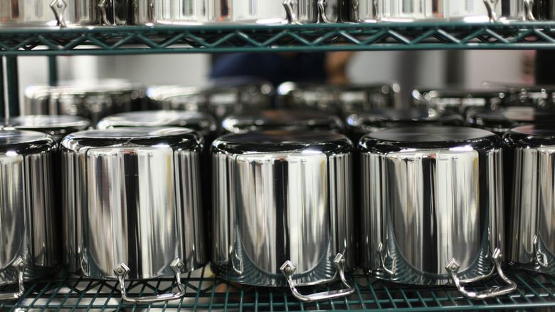 A line of stainless steel pots