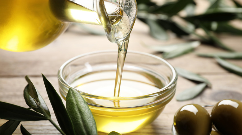 Olive oil being poured into a dish