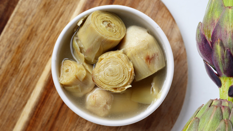 White bowl full of artichoke hearts