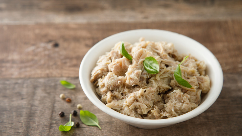 White bowl of canned chicken meat