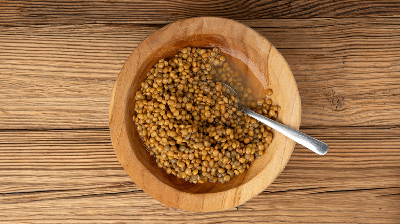 Wooden bowl of cooked lentils