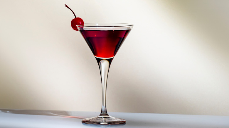 Manhattan cocktail in a martini glass with a cherry garnish
