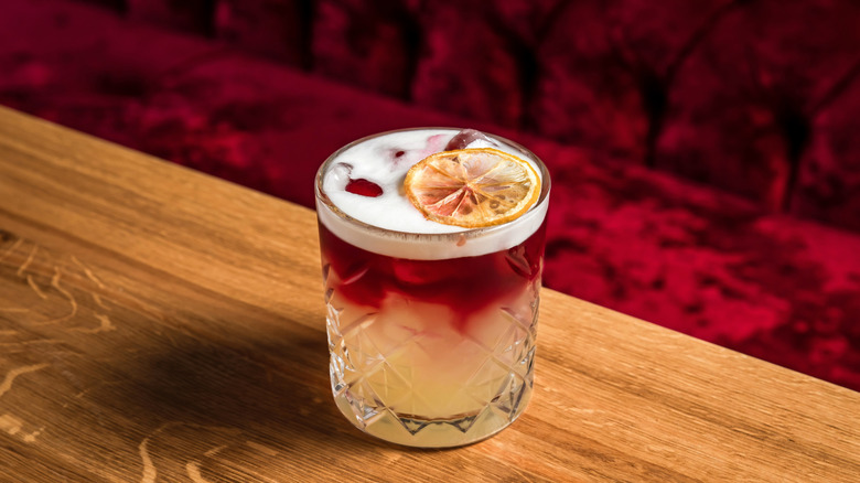 New York Sour cocktail in rocks glass on a wooden bar
