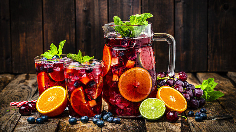 Pitcher and two glasses of red Sangria with fruit