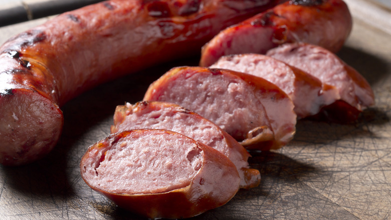 Sliced grilled kielbasa on a cutting board